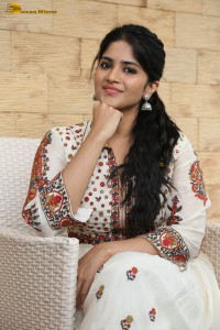 actress megha akash in a white shirt and skirt