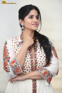 actress megha akash in a white shirt and skirt