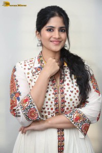 actress megha akash in a white shirt and skirt