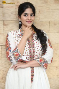 actress megha akash in a white shirt and skirt