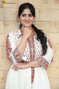actress megha akash in a white shirt and skirt