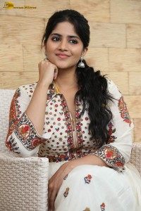 actress megha akash in a white shirt and skirt