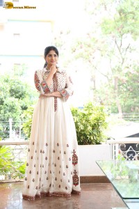 actress megha akash in a white shirt and skirt