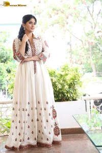 actress megha akash in a white shirt and skirt