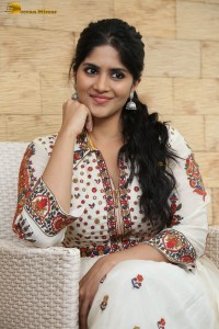 actress megha akash in a white shirt and skirt