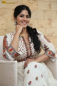 actress megha akash in a white shirt and skirt