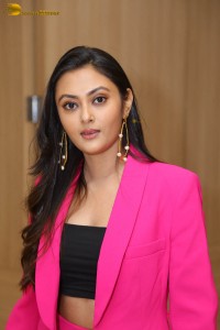 Tollywood actress megha chowdhury in a black top and pink overcoat