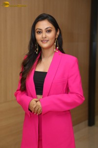 Tollywood actress megha chowdhury in a black top and pink overcoat