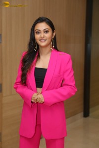 Tollywood actress megha chowdhury in a black top and pink overcoat