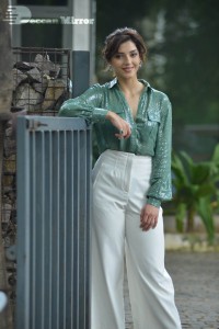 Actress Mehreen in green shirt and white pants