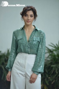 Actress Mehreen in green shirt and white pants