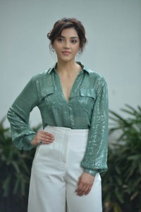 Actress Mehreen in green shirt and white pants