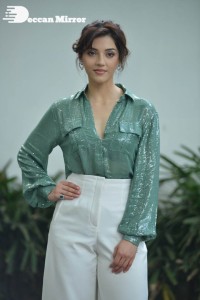 Actress Mehreen in green shirt and white pants