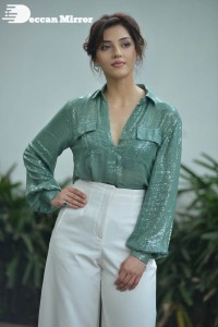 Actress Mehreen in green shirt and white pants