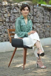 Actress Mehreen in green shirt and white pants