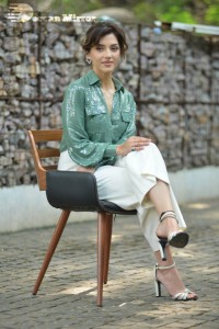 Actress Mehreen in green shirt and white pants