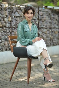 Actress Mehreen in green shirt and white pants