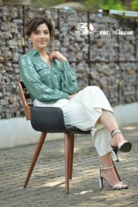 Actress Mehreen in green shirt and white pants