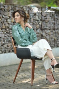 Actress Mehreen in green shirt and white pants