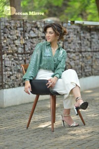 Actress Mehreen in green shirt and white pants