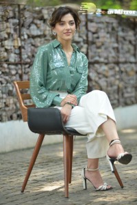 Actress Mehreen in green shirt and white pants