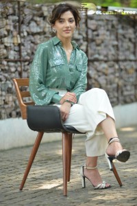 Actress Mehreen in green shirt and white pants