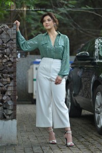Actress Mehreen in green shirt and white pants