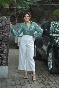 Actress Mehreen in green shirt and white pants