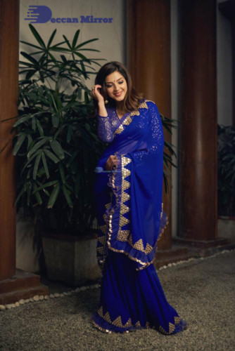 Mehreen in a dark blue saree