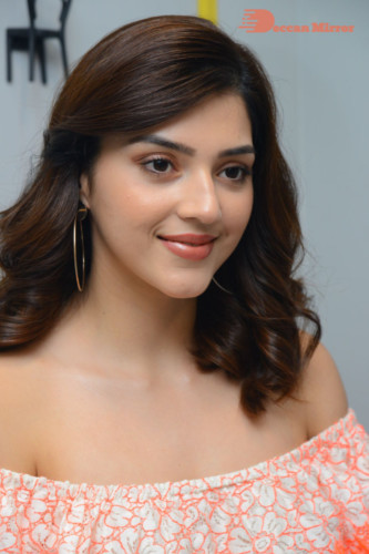 Actress Mehreen in a orange dress