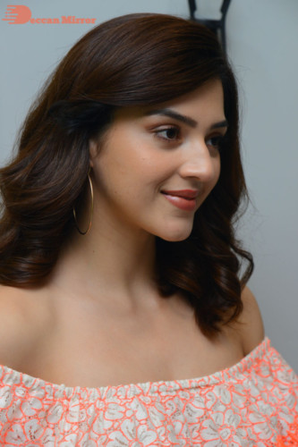 Actress Mehreen in a orange dress