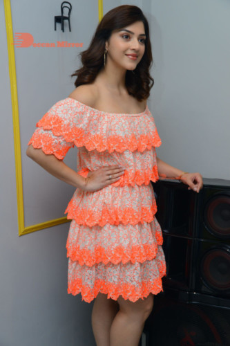 Actress Mehreen in a orange dress