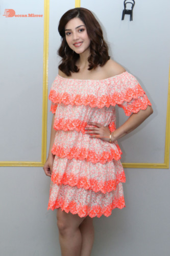 Actress Mehreen in a orange dress