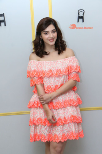 Actress Mehreen in a orange dress