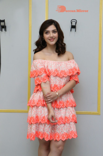 Actress Mehreen in a orange dress
