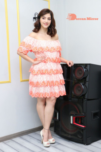 Actress Mehreen in a orange dress