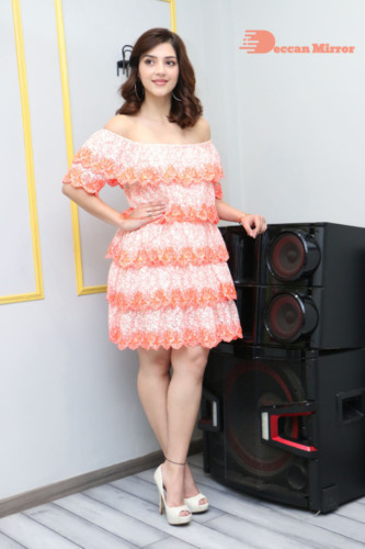 Actress Mehreen in a orange dress