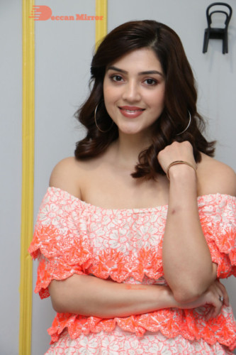 Actress Mehreen in a orange dress