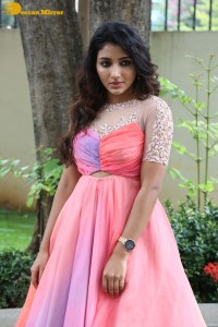 Indian Actress Mirnaa Menon in a pink dress