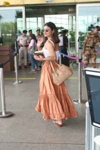 actress Mouni Roy pretty in a white top and orange skirt