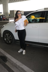 Mouni Roy at Airport in a white top