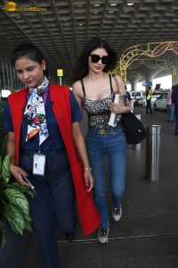 actress Mouni Roy cute in a noodle strap top and blue denim jeans at airport