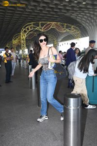 actress Mouni Roy cute in a noodle strap top and blue denim jeans at airport