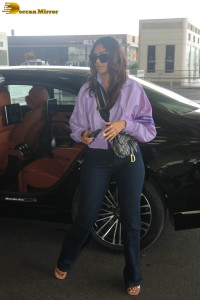 actress mrunal thakur in a purple shirt at airport