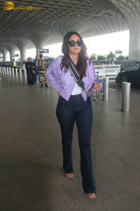 actress mrunal thakur in a purple shirt at airport