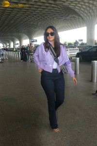 actress mrunal thakur in a purple shirt at airport