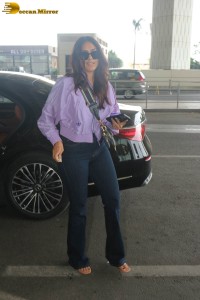 actress mrunal thakur in a purple shirt at airport