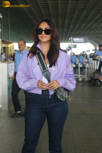 actress mrunal thakur in a purple shirt at airport