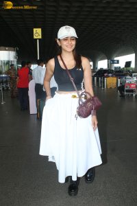 actress mrunal thakur in a black top and white skirt at airport