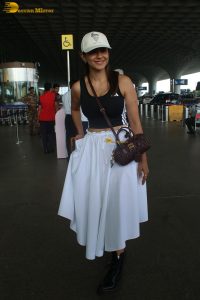 actress mrunal thakur in a black top and white skirt at airport